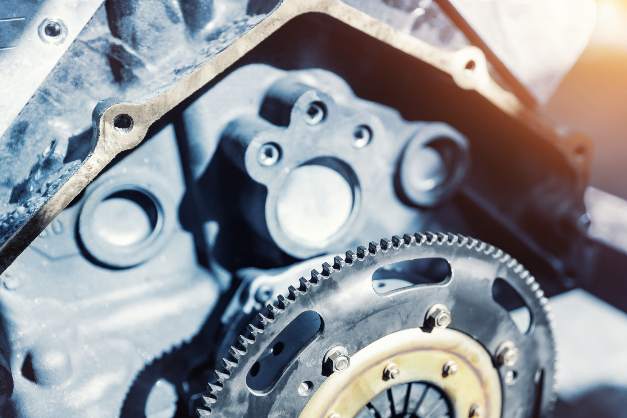 Close-up of a metallic engine component with gears and bolts.