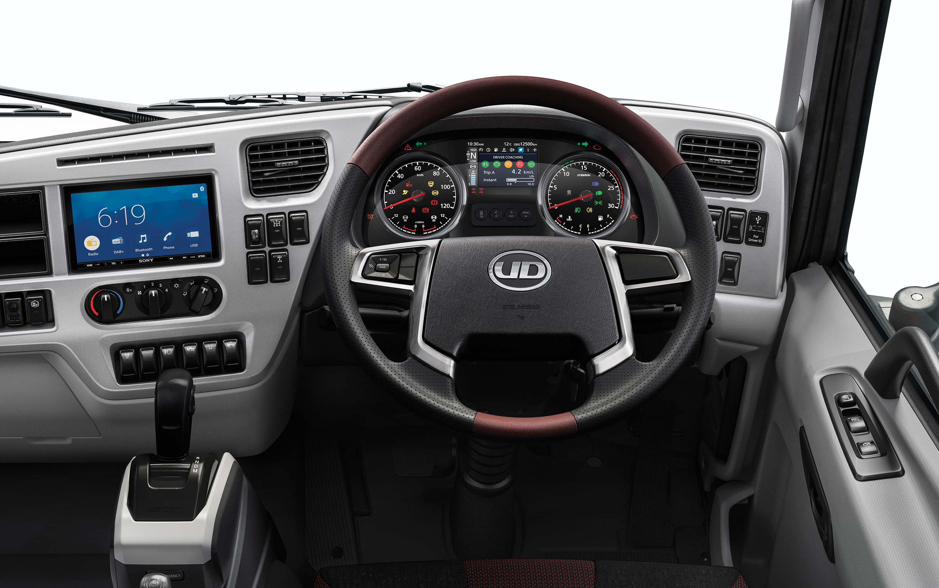 Modern truck dashboard with digital displays, a steering wheel, and various controls.