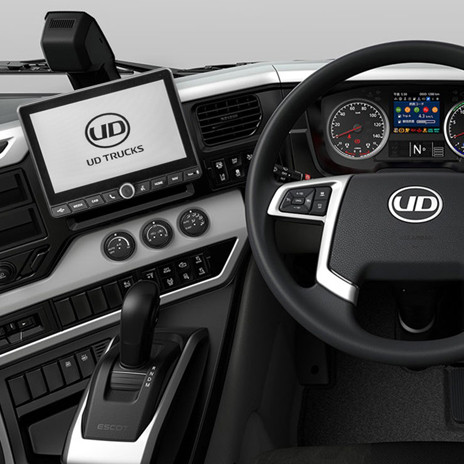 Modern UD Trucks dashboard with multi-function steering wheel and digital displays.