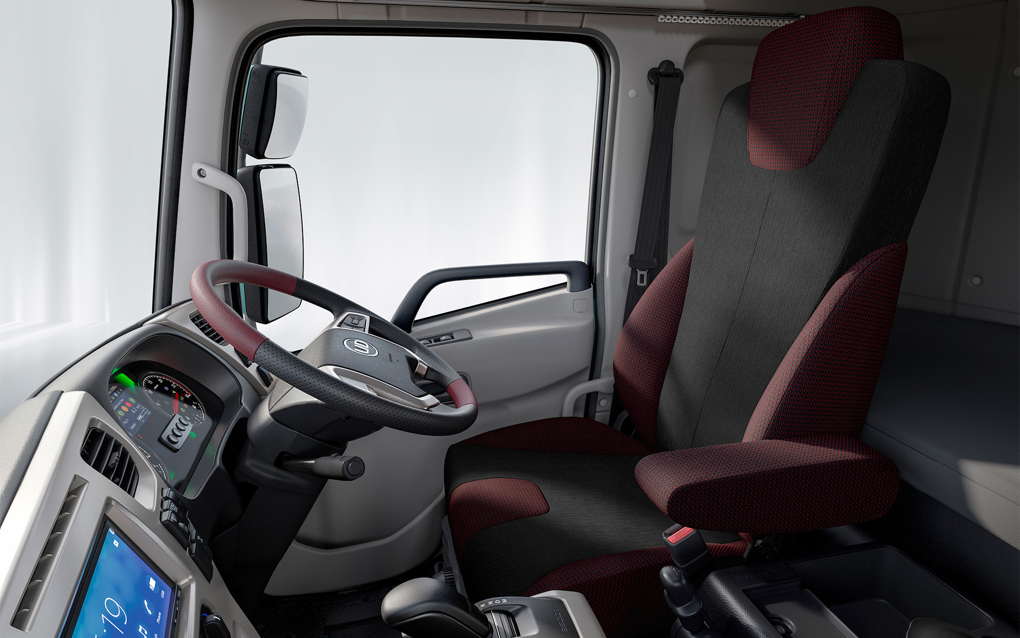 Modern truck cab interior with a red and black driver's seat and digital dashboard.